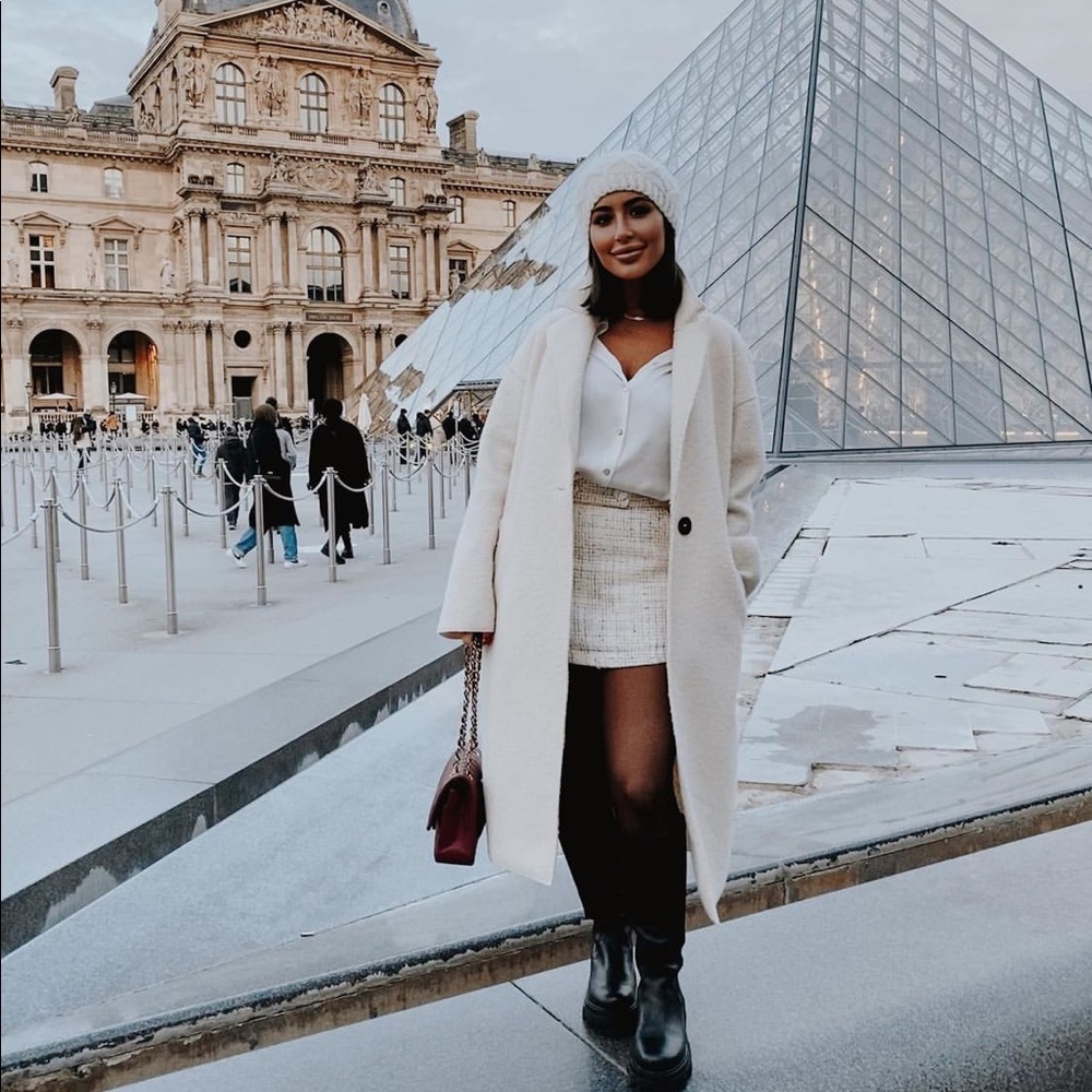 White coat with black buttons. Can include hat for $10 extra